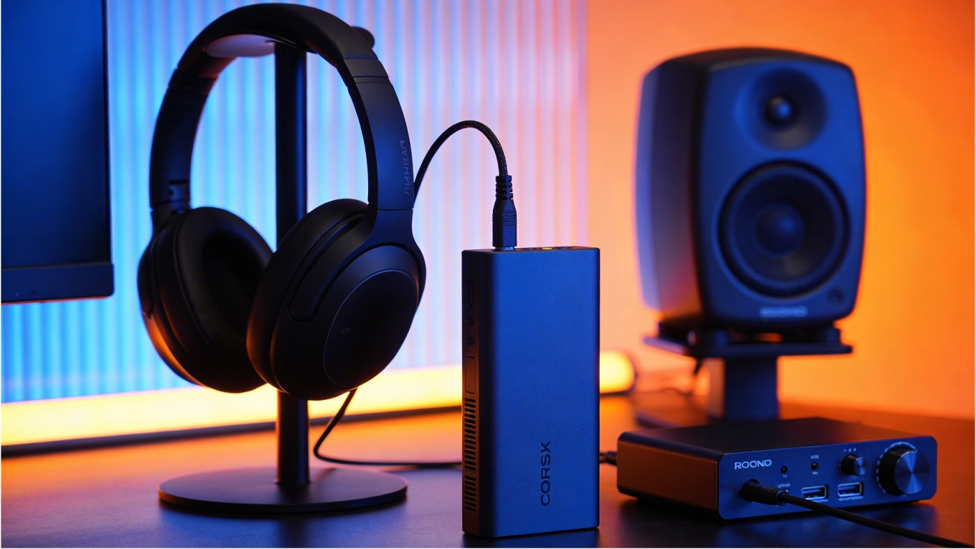 Audio equipment including headphones and speakers displayed in a clean modern layout