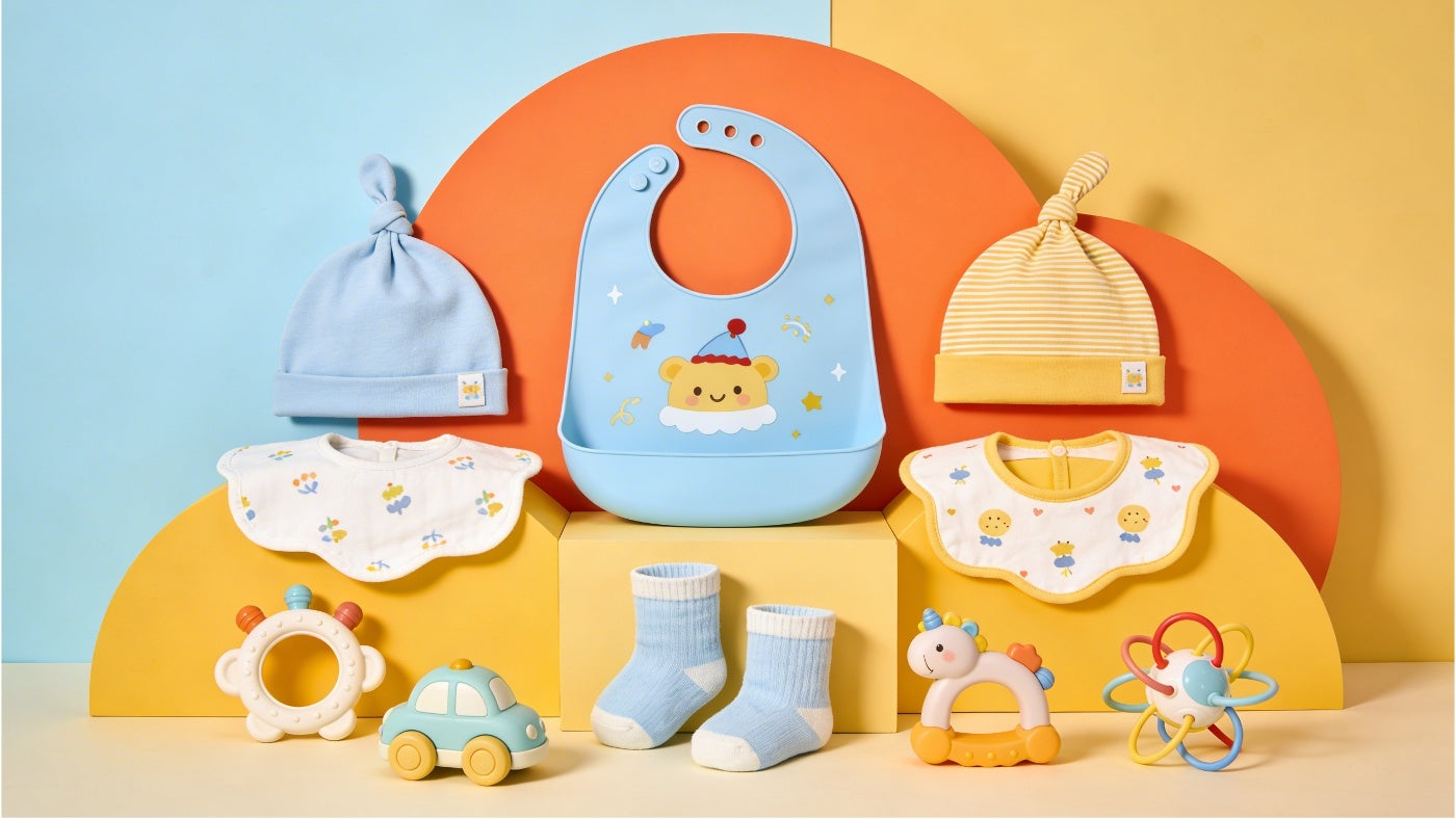 Baby accessories including bibs, hats, socks and toys in a colorful display at affordable prices