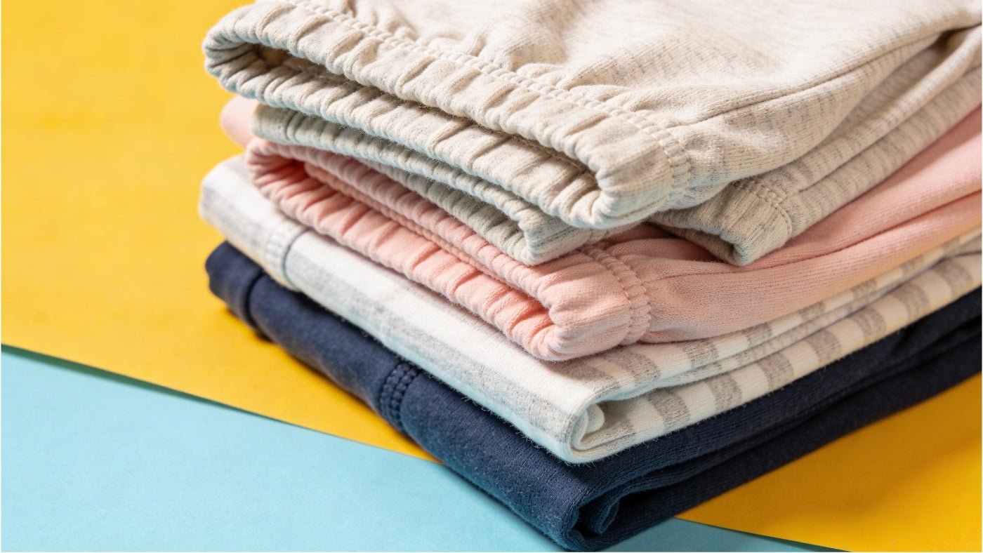 Baby bottoms including pants and leggings neatly arranged in a bright colorful display