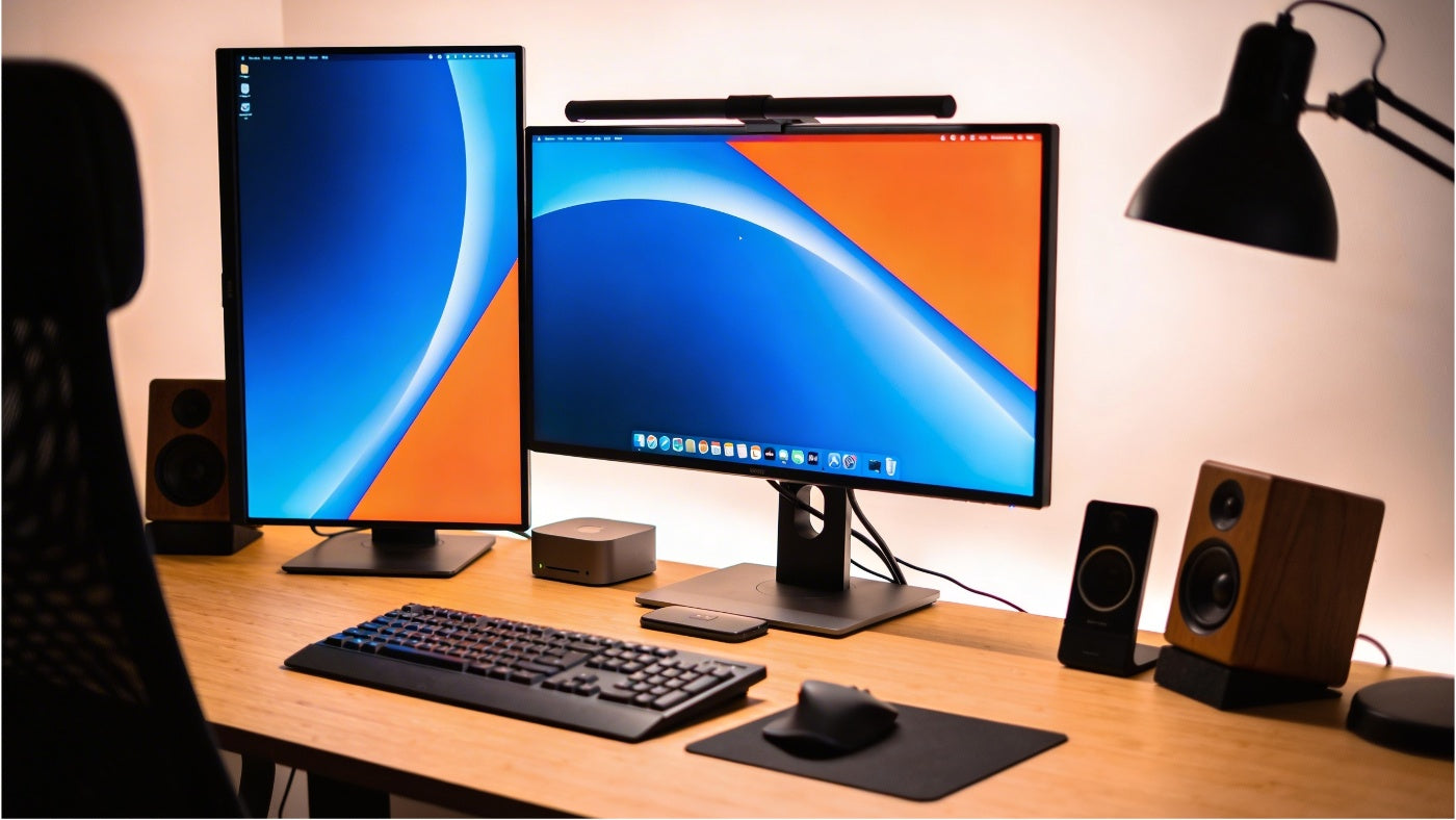 Computer monitors displayed in a clean modern setup with bright screen visuals