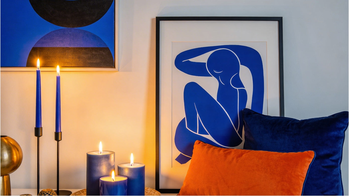 Home decor items including candles pillows and wall art displayed in a clean modern setting