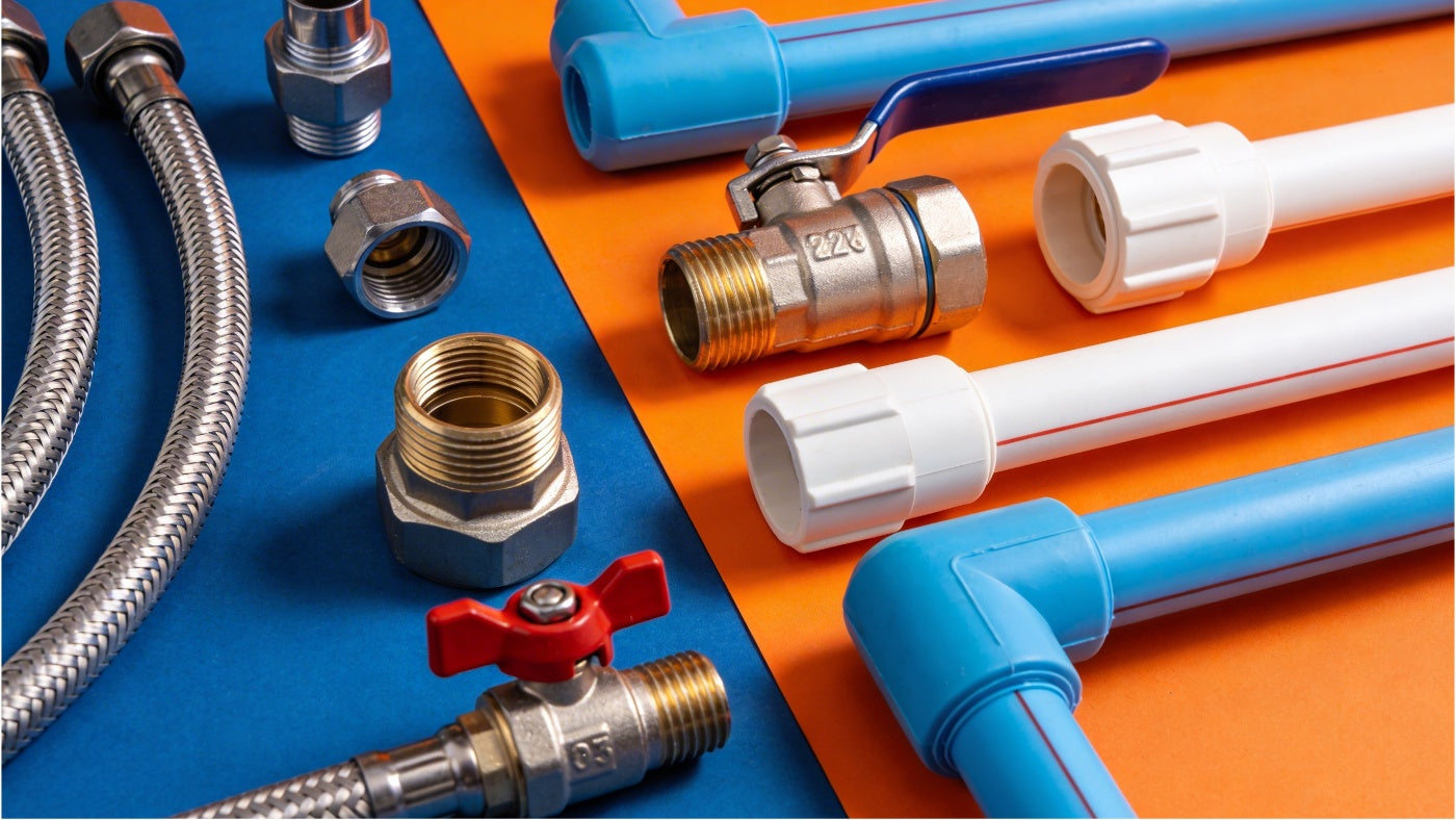 Plumbing supplies including pipes fittings and valves arranged in a clean organized display
